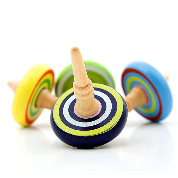 istock Four colorful wooden Spinning tops iver white background 470835260