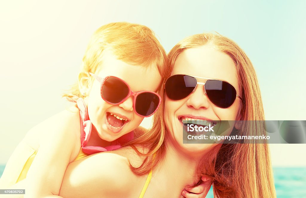 happy family on the beach. mother and baby daughter happy family on the beach. mother and baby daughter  at sea 2015 Stock Photo