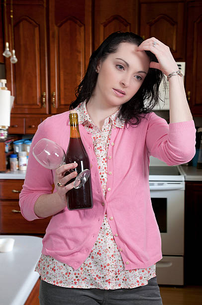 Woman with Wine Beautiful woman holding a bottle of wine psycological stock pictures, royalty-free photos & images