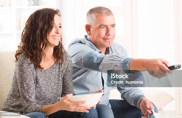 Couple Watching Tv In Their Living Room Stock Photo - Download Image Now - Active Seniors, Adult, Adults Only