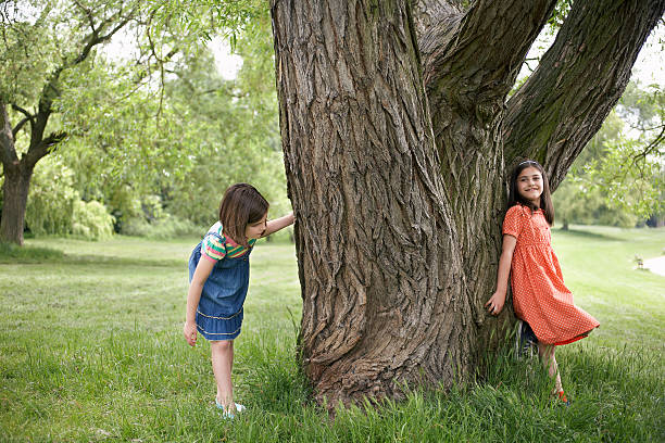 istock Girls Playing Hide And Seek By Tree 470839105