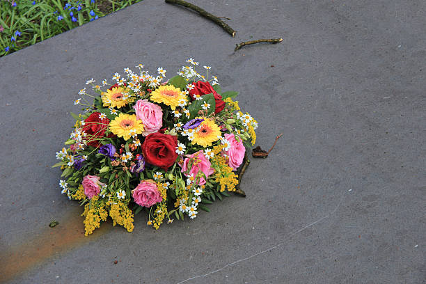 istock Sympathy flowers on a tombstone 470841282