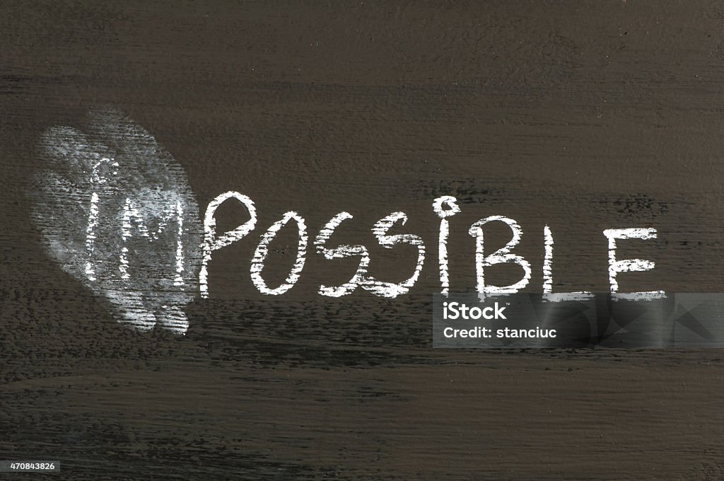 Impossible replaced by possible Impossible replaced by possible message isolated on black background. Chalk drawing on blackboard. Business Concept image. 2015 Stock Photo