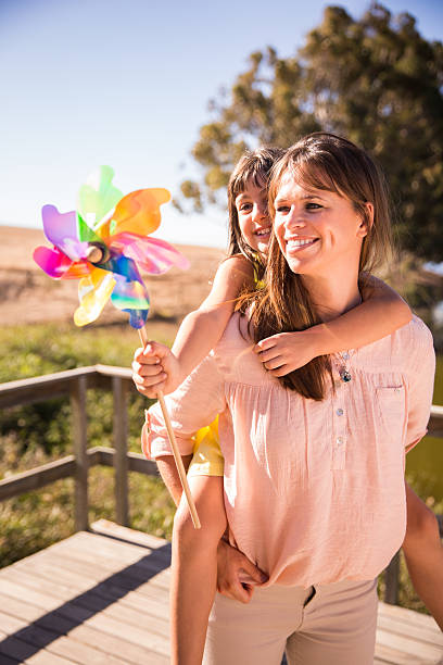 istock Mother and daughter outside with a colourful windmill 470844098