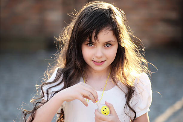 Attractive little girl in the street looking forward, horizontal photo