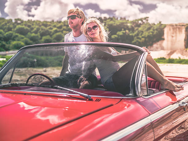 istock Happy young people in convertible car 470846630