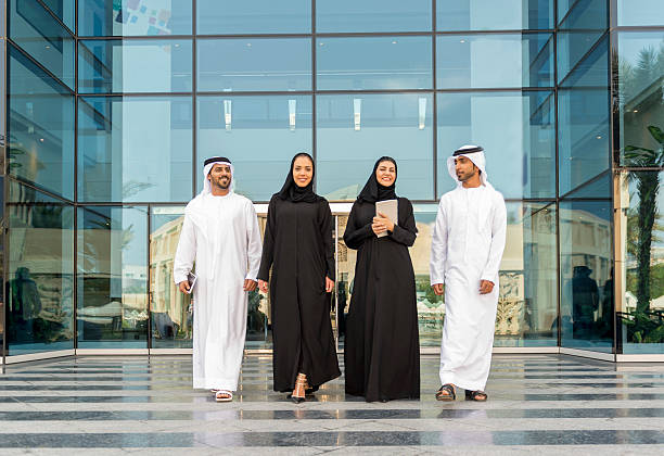 young business people walking out of glass building - arabistan stok fotoğraflar ve resimler