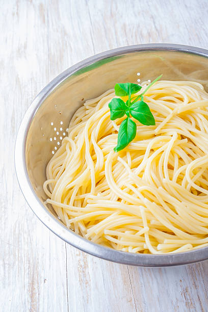 istock cooked pasta in the strainer on white wooden table 470850068