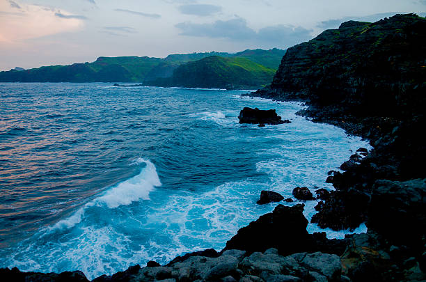 Large waves crashing in over Maui's volcanic north shore. stock photo