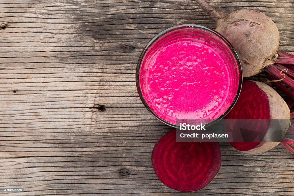 Beetroot juice on wooden background, top view Beetroot juice with fresh beetroot on wooden background, top view, with copy space Beet Stock Photo