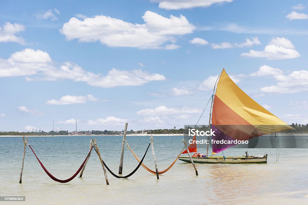 sail boat and hammocks at Jericoacoara, Brazil beautiful sail boat and hammocks at the Paradise Lake (Jericoacoara, Brazil) Jeriquaquara Beach Stock Photo