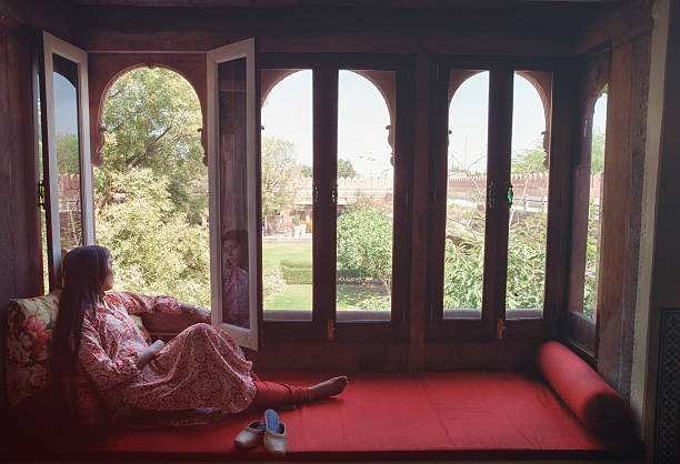 istock Young Indian Woman Relaxing in a Window Nook 470856400