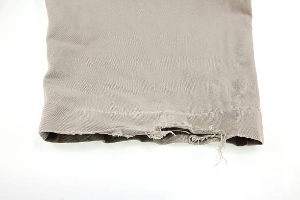 istock Closeup of tear in old pant 470858304