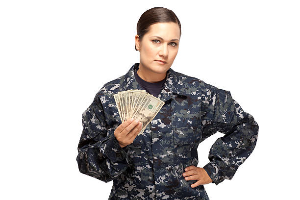 istock Female navy sailor with money 470858482