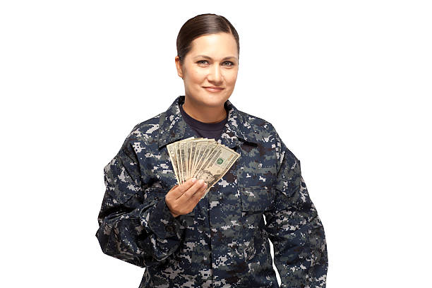 istock Smiling female navy sailor with money 470858486