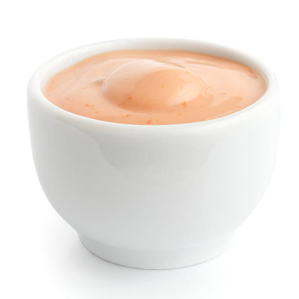 Small white ceramic dish of American mustard. Isolated.
