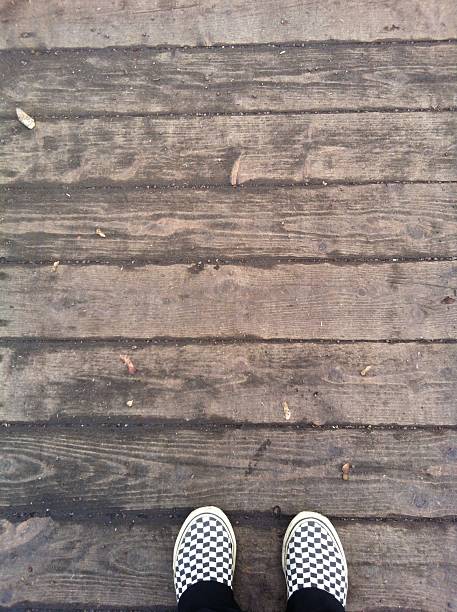 istock feet on the wooden floor 470870334