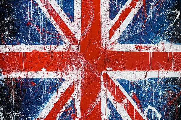 Painted concrete wall with graffiti of British flag. Grunge flag of United Kingdom. Union Jack