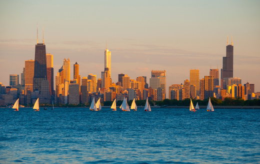 Chicago downtown skyline with Lake Michigan and many sailboats in the foreground.