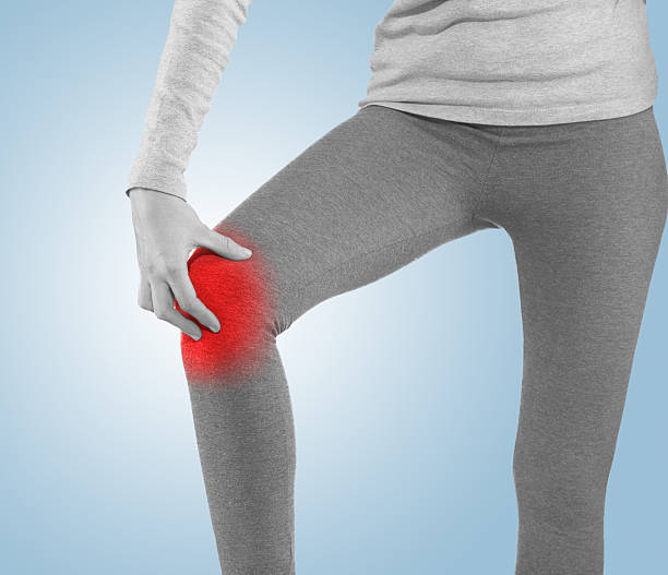 istock woman having pain in his knee making massage. 470876848