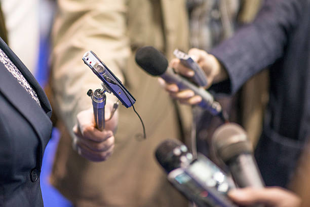 istock Close up of microphones and recorders held out for interview 470877640