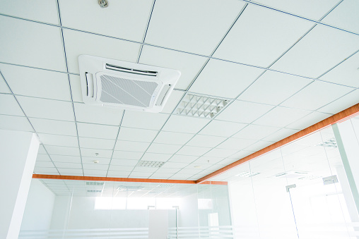 Air conditioning system installed on the ceiling of modern office building.