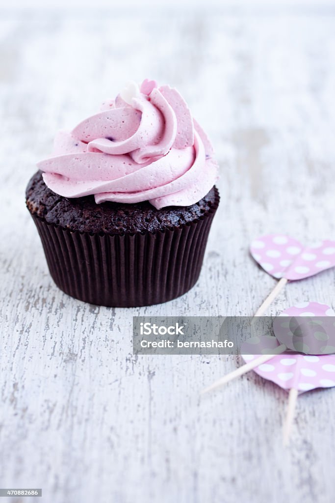 pink chocolate cupcake pink chocolate cupcake on a wooden table 2015 Stock Photo