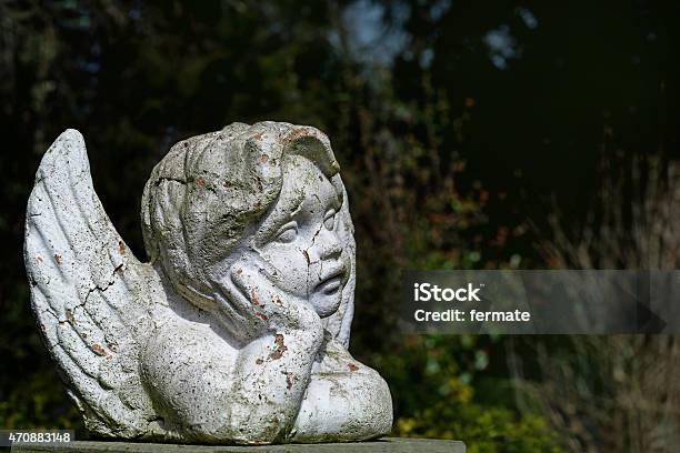Putto Child Angel Statue Of Ceramic With Flaking White Paint Stock Photo - Download Image Now