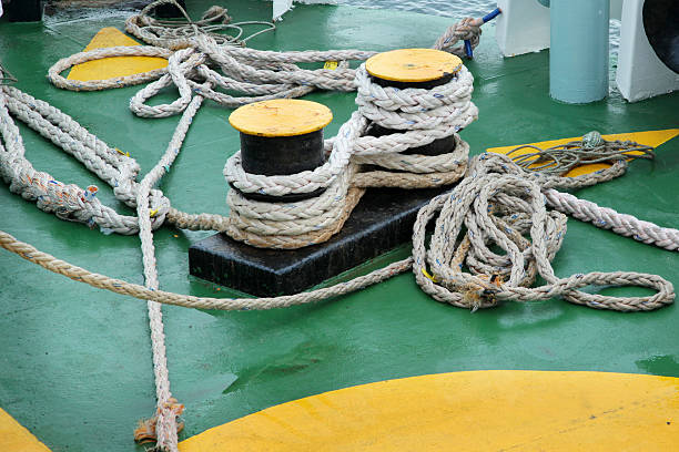 istock Old ropes around mooring bollard in a deck 470885117