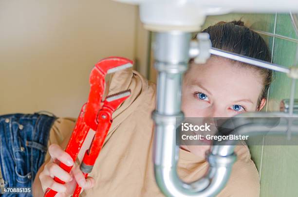 Woman Repairing A Siphon Stock Photo - Download Image Now - Pipe - Tube, Below, Sink