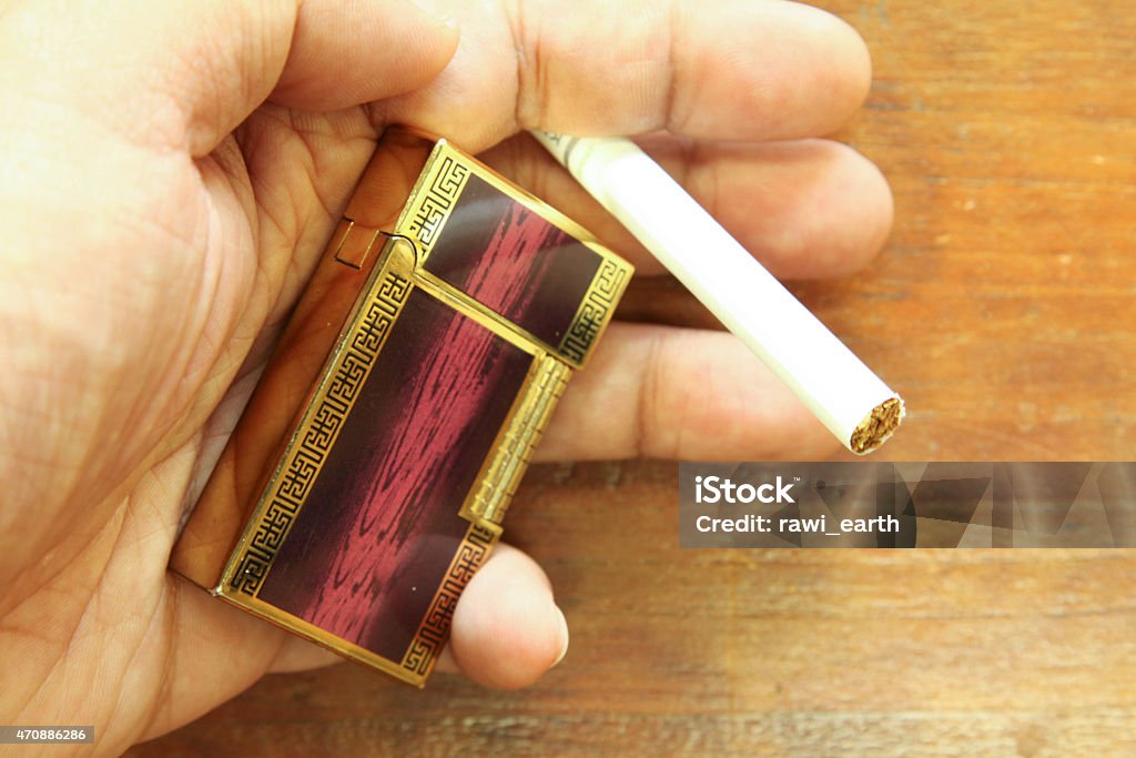 Lighter and Cigarette on the hand. 2015 Stock Photo