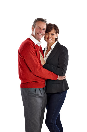 Portrait of romantic mature couple embracing on white background