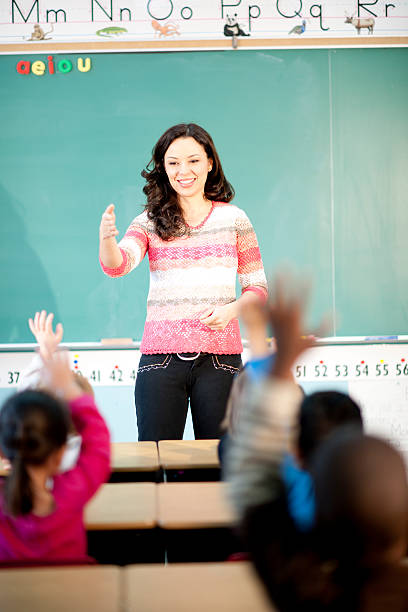 学生の手を上げるクラス - 4th graders ストックフォトと画像