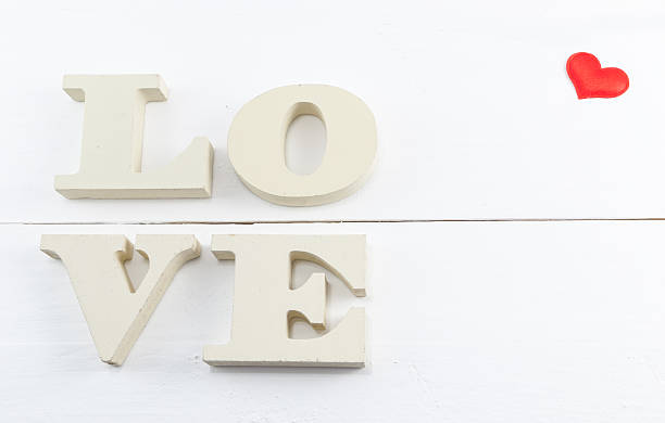 istock Word love with heart shaped on white wooden background 470892212