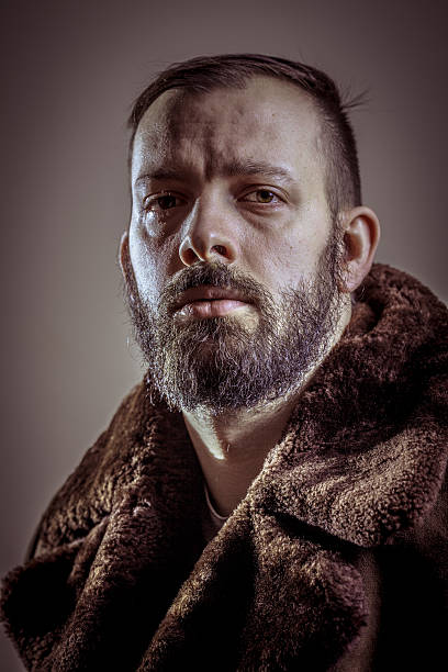 istock Young handsome bearded man in the coat 470898588