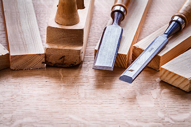 istock chisels and plane planks on wooden board 470899618