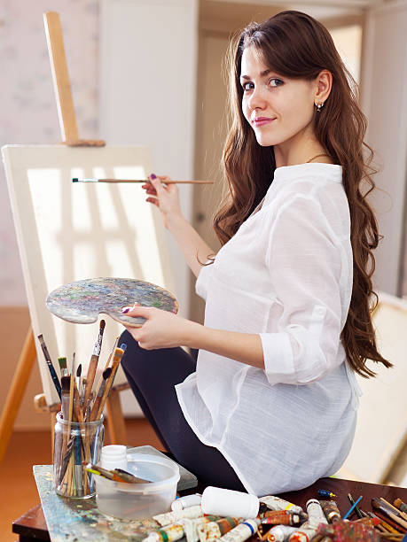 istock artist with oil colors and brushes 470900897