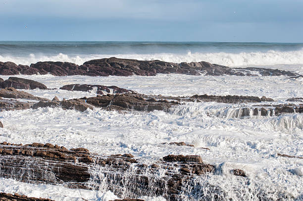 Surf on the rocks stock photo