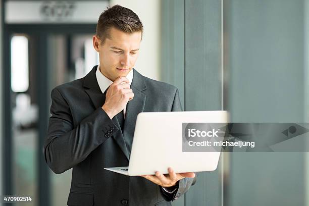 Businessman Reading Email On His Laptop Stock Photo - Download Image Now - Businessman, Laptop, 2015