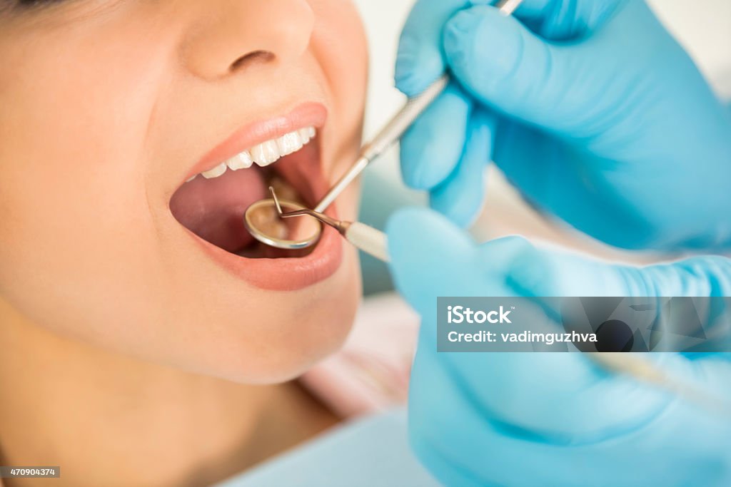 Close-up of woman having dental examination Dentist examining a patient's teeth in the dentist. 2015 Stock Photo