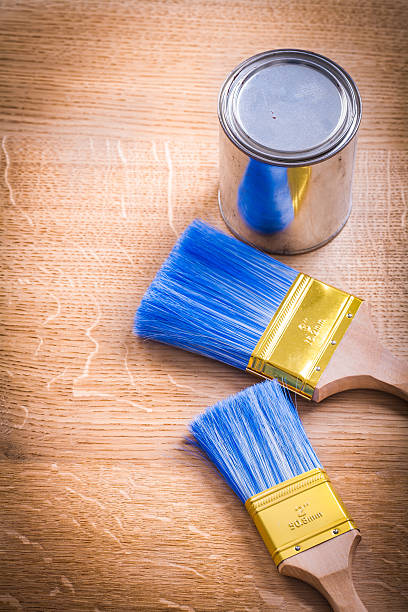 istock paint brushes and can on wooden board 470904420