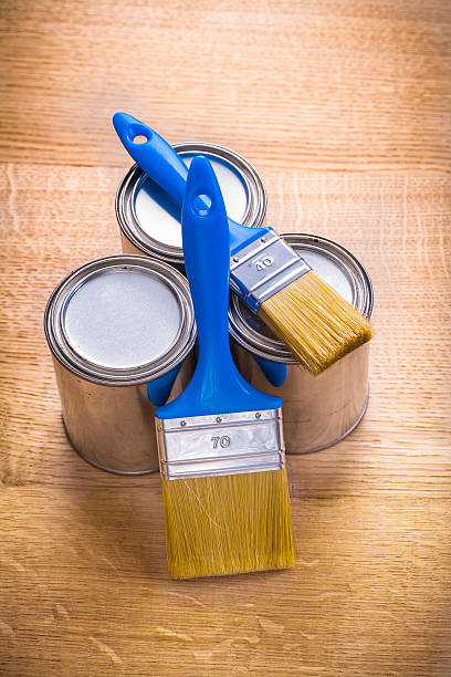 istock composition of two paint brushes and three cans on wooden 470906684