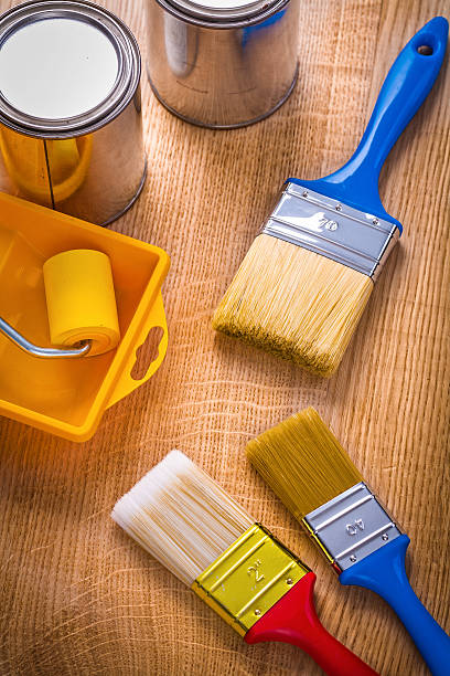 istock tray roller paint brushes cans on wooden board 470908536