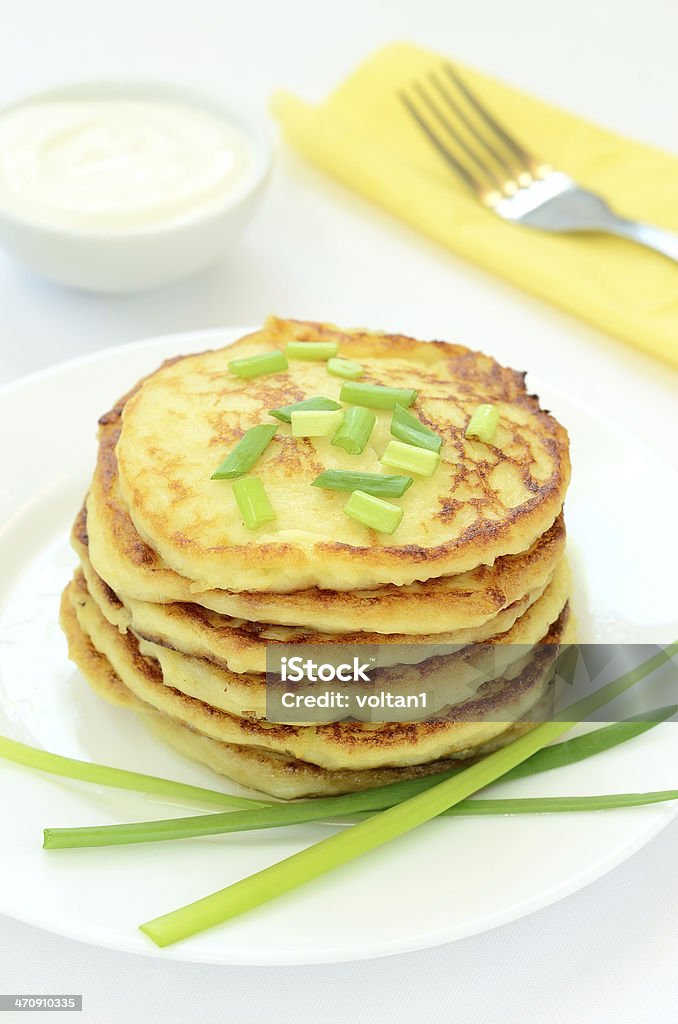 Potato pancakes with green onion Potato pancakes with green onion on white plate Appetizer Stock Photo