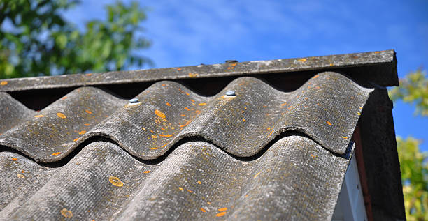 istock Blue sky over the dangerous asbestos old roof tiles 470913080