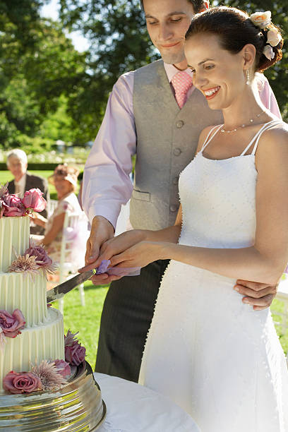 istock Bride And Groom Cutting Wedding Cake 470913123