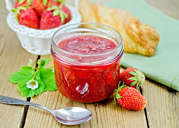 istock Jam of strawberry with a bun on the board 470914231