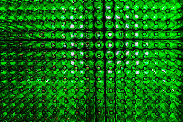 istock green glass bottles lined on wall with light behind 470915138
