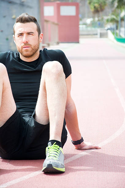 istock Man sitting on the running track 470918308