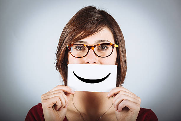 istock Pretty Young Woman with Smiley Emoticon 470918861